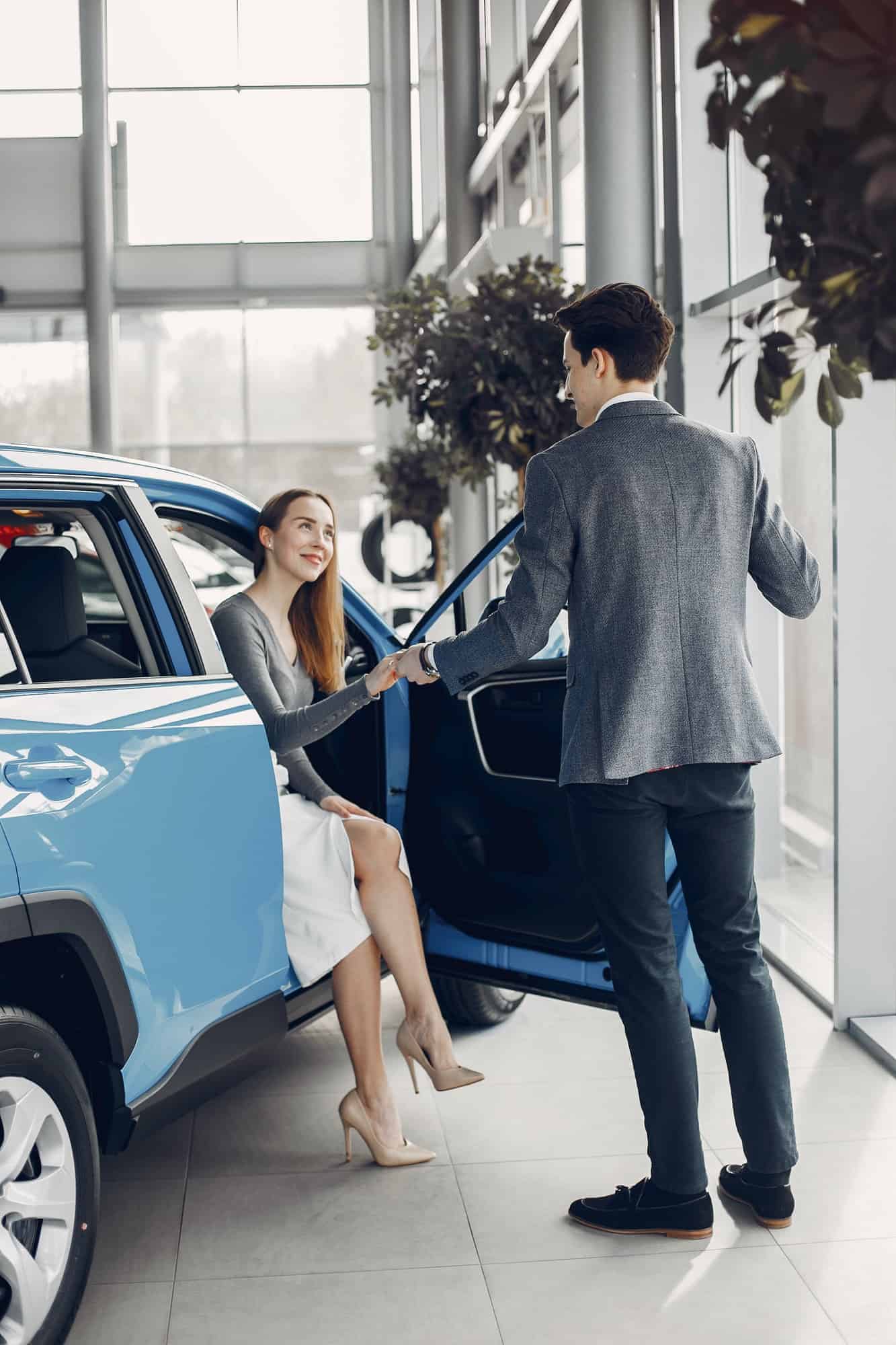 elegant couple in a car salon